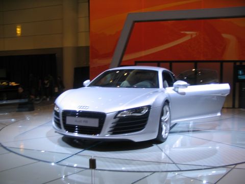 1993 Ford Taurus - Audi R8 on display at an auto show, with the driver's side door open.