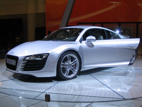 1993 Ford Taurus - A silver Audi R8 is displayed with its driver's side door open, its interior and the car's design.