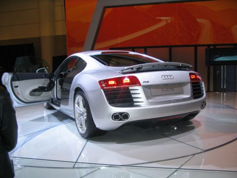 1993 Ford Taurus - Silver Audi R8 coupe displayed with doors open at an auto show.