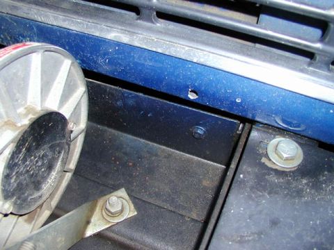 1979 Ford Bronco - Close-up view of the front end components of a 1979 Ford Bronco, showing painted metal and a horn.