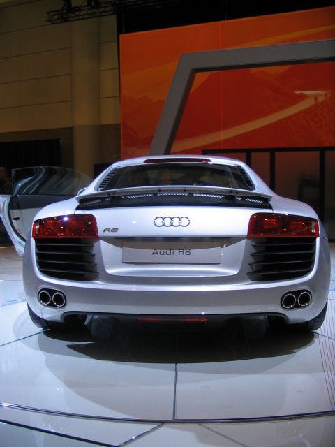 1993 Ford Taurus - Silver Audi R8 sports car displayed at an auto show, showing its rear design and exhaust.