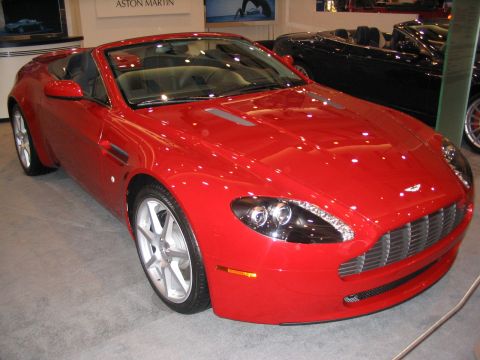 1993 Ford Taurus - Red convertible sports car on display, with another black convertible behind it.