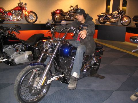 1993 Ford Taurus - Man on a blue motorcycle at a display with other motorcycles in the background.