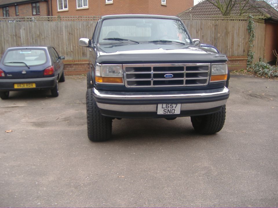 Front of dark Ford pickup with UK plate L657 SNO on a driveway