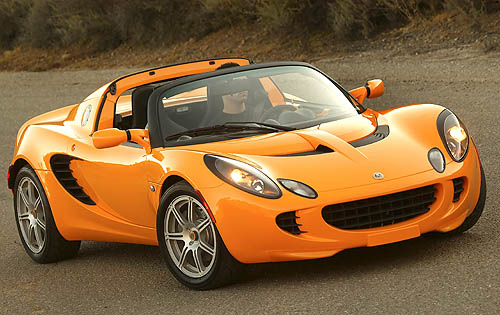 Orange convertible roadster, top down, front three-quarter view on pavement
