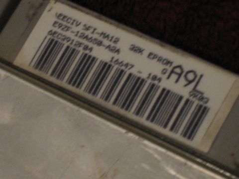 1994 Ford Bronco - Close-up of an engine control unit label showing part numbers and a barcode.