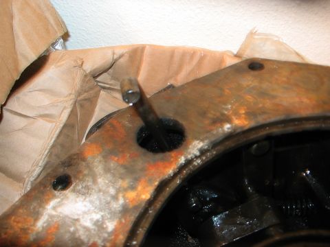 1991 Ford Bronco - A close-up view of a rusty metal part, possibly from a vehicle's drivetrain, with a pin inserted into a hole.