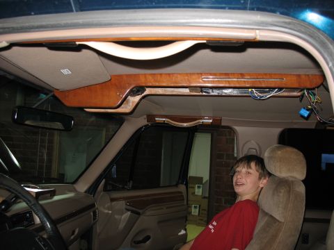 1995 Ford C-350 (Centurion Conversions) - Interior view of a vehicle's overhead console wood trim and visible wiring.