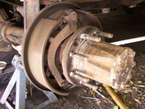 1995 Ford C-350 (Centurion Conversions) - Close-up view of Sterling disc brakes on a vehicle's rear axle, showing the brake drum and caliper assembly.