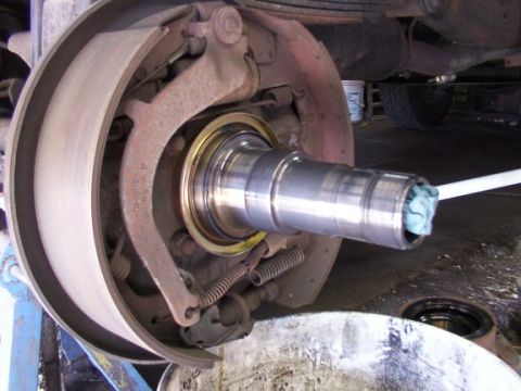1995 Ford C-350 (Centurion Conversions) - Close-up view of a truck's brake drum and axle assembly, showing the brake shoes and drum interior.