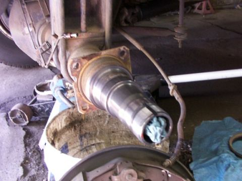 1995 Ford C-350 (Centurion Conversions) - Close-up of a vehicle's rear axle spindle, possibly undergoing maintenance or repair.