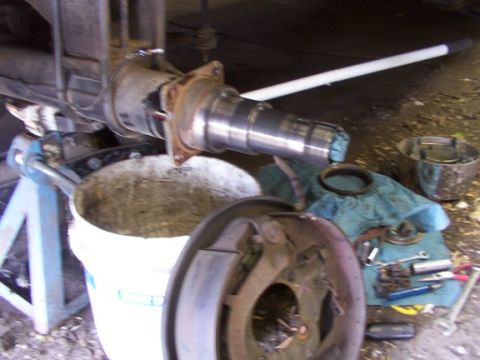 1995 Ford C-350 (Centurion Conversions) - Disassembled vehicle axle and brake components, likely during maintenance or repair.