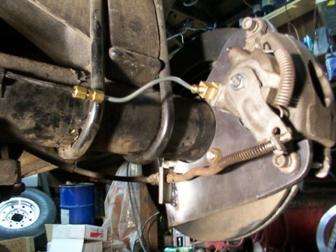 1995 Ford C-350 (Centurion Conversions) - Rear brake assembly detail, showing caliper, rotor, and brake lines.