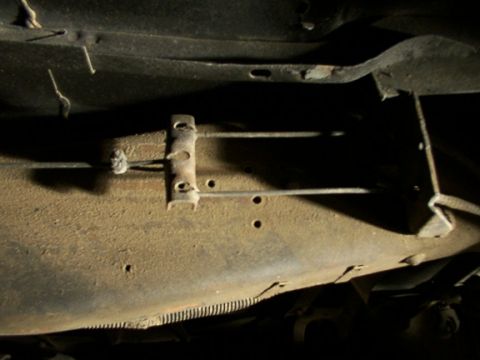 1995 Ford C-350 (Centurion Conversions) - Close-up view of brake lines and chassis components on the underside of a vehicle.
