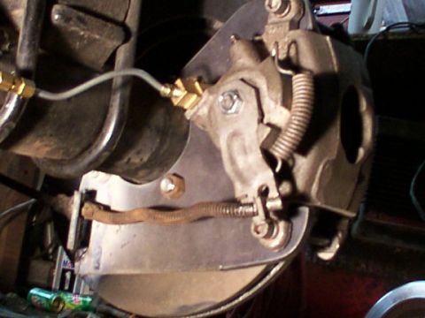 1995 Ford C-350 (Centurion Conversions) - Close-up view of a vehicle's brake caliper and rotor assembly.