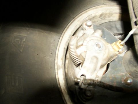 1995 Ford C-350 (Centurion Conversions) - Detail of a vehicle's brake system, focusing on the caliper and tire.