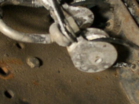 1995 Ford C-350 (Centurion Conversions) - This is a close-up view of a brake line bracket attached to a vehicle's chassis.