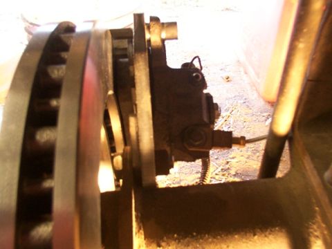 1995 Ford C-350 (Centurion Conversions) - Close-up view of a vehicle's disc brake assembly, showing the caliper and rotor components.