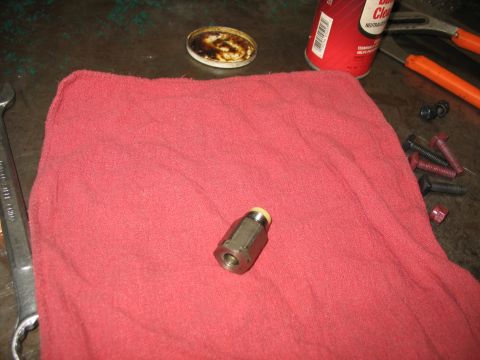 1995 Ford C-350 (Centurion Conversions) - A close-up of a brake line fitting on a red cloth, with various tools and a can of brake cleaner in the background.