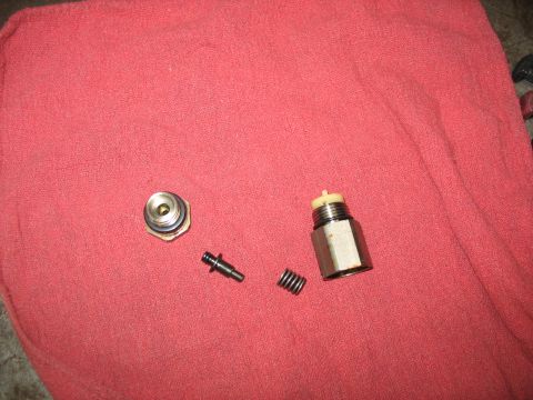 1995 Ford C-350 (Centurion Conversions) - Disassembled brake pressure differential valve components lie on a red cloth.