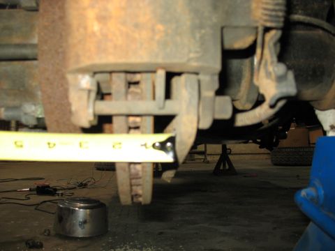 1995 Ford C-350 (Centurion Conversions) - Measuring the brake caliper and rotor assembly on a vehicle.