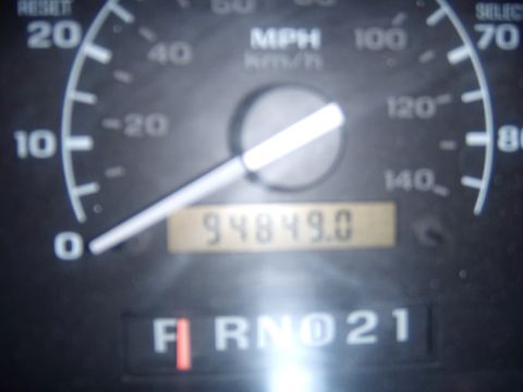 1992 Ford Bronco - Vehicle's dashboard displays speed, mileage, and gear selection.
