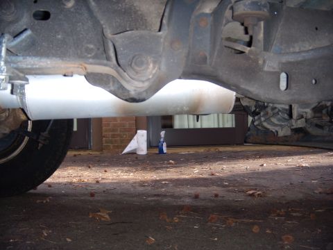 1992 Ford Bronco - Close-up view of the undercarriage, showing the exhaust system and suspension components.