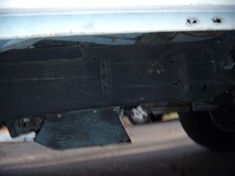 1992 Ford Bronco - Undercarriage view of a vehicle, showing frame and part of a tire.