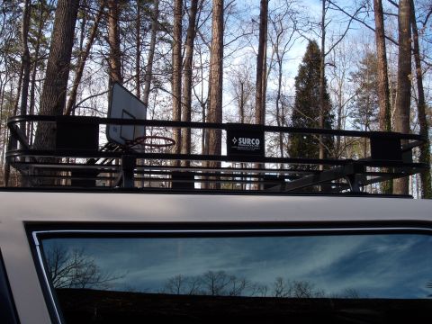 1992 Ford Bronco - A roof rack is mounted on top of a vehicle, with a basketball hoop visible.