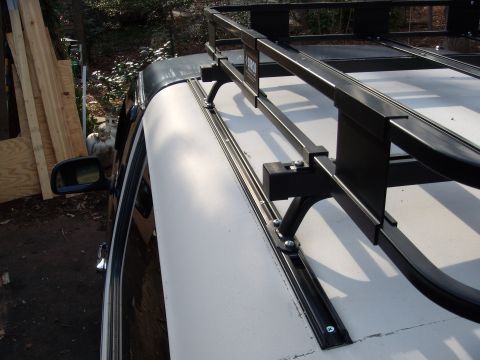 1992 Ford Bronco - A black roof rack system is mounted to the side of a white vehicle.