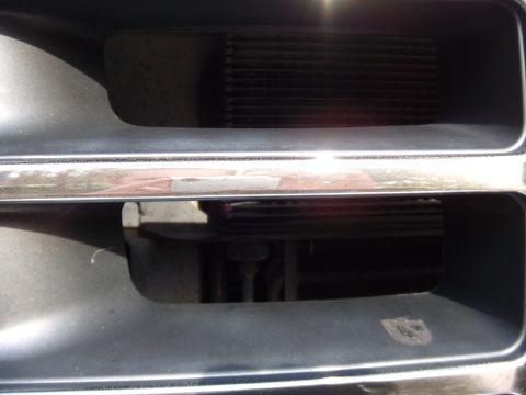 1992 Ford Bronco - A close-up view of a vehicle's front grille, showing the radiator behind the bars.