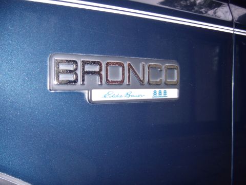 1992 Ford Bronco - Close-up of a Ford Bronco Eddie Bauer emblem on a blue vehicle.