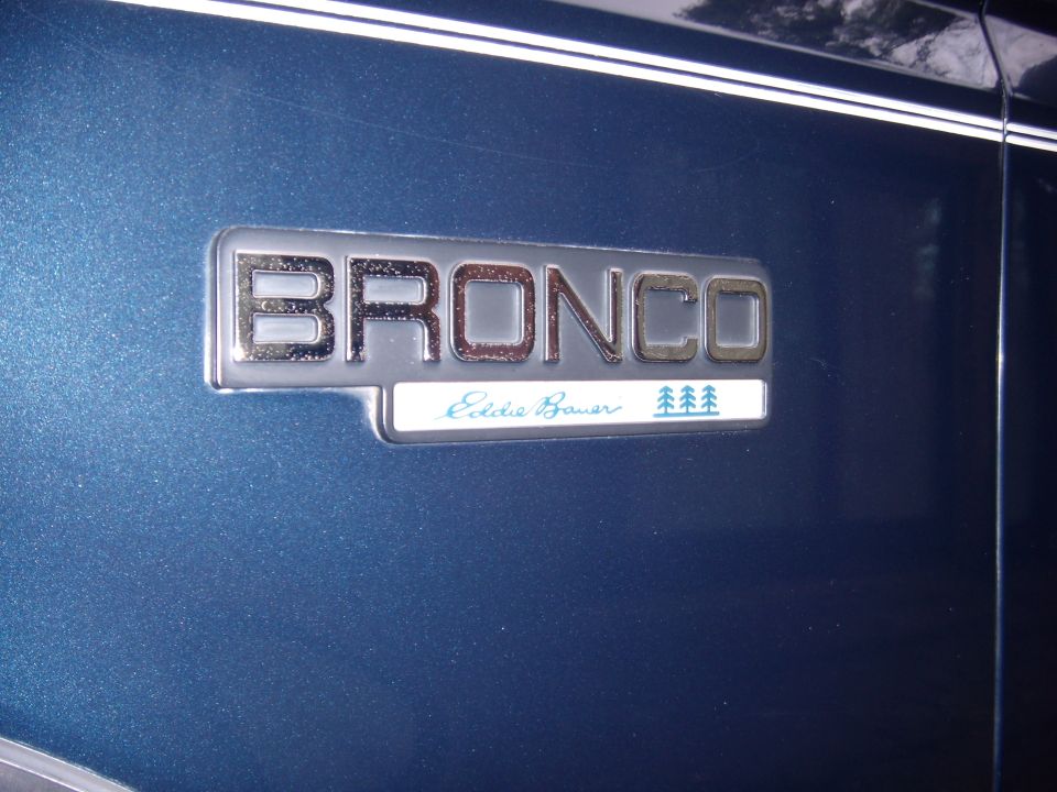 Blue Ford Bronco Eddie Bauer emblem on a dark blue vehicle