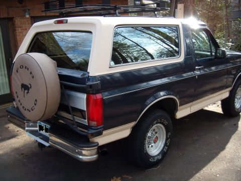 1992 Ford Bronco - Rear view of a 1992 Ford Bronco, showing the spare tire cover with the Ford Bronco logo.