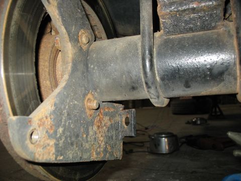 1995 Ford C-350 (Centurion Conversions) - Close-up view of heavily rusted suspension components, including the axle housing and a U-bolt.