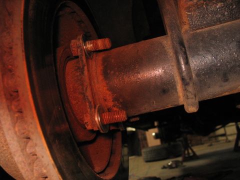 1995 Ford C-350 (Centurion Conversions) - The wheel hub and axle assembly shows significant rust and wear.