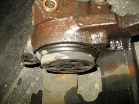 1995 Ford C-350 (Centurion Conversions) - Close-up view of a greasy brake caliper, showing its internal components.