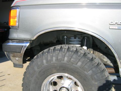 1989 Ford Bronco - Close-up of the front fender, wheel well, and tire on a 1989 Ford Bronco.