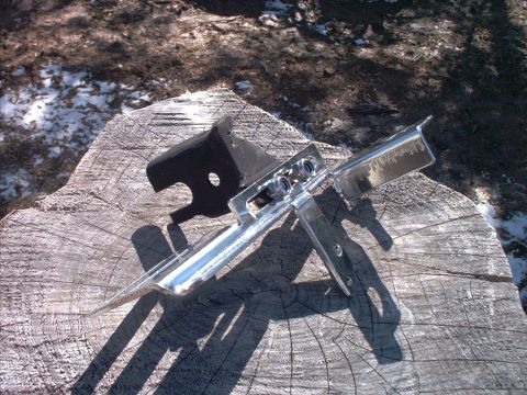 1985 Ford Bronco - A fabricated steel bracket assembly with a bright zinc-plated finish and a black-painted mounting plate, bolted together with three visible…