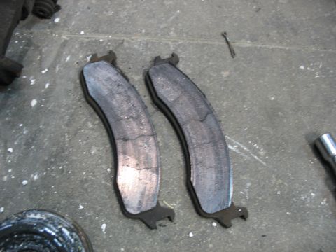 1995 Ford C-350 (Centurion Conversions) - These brake pads show significant wear and cracking, indicating they are due for replacement.