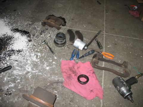 1995 Ford C-350 (Centurion Conversions) - Disassembled brake parts and tools are laid out on the floor, suggesting a repair or maintenance job is in progress.
