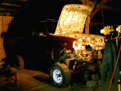 2001 Dodge 2500 - Truck undergoing repairs in a garage, hood open revealing the engine.