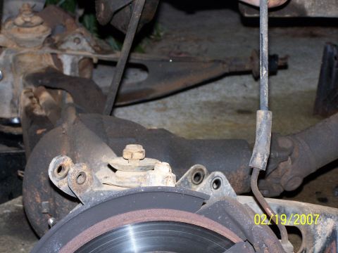 1979 Ford F-150 - Close-up of rusty vehicle suspension components and brake rotor with a date stamp.