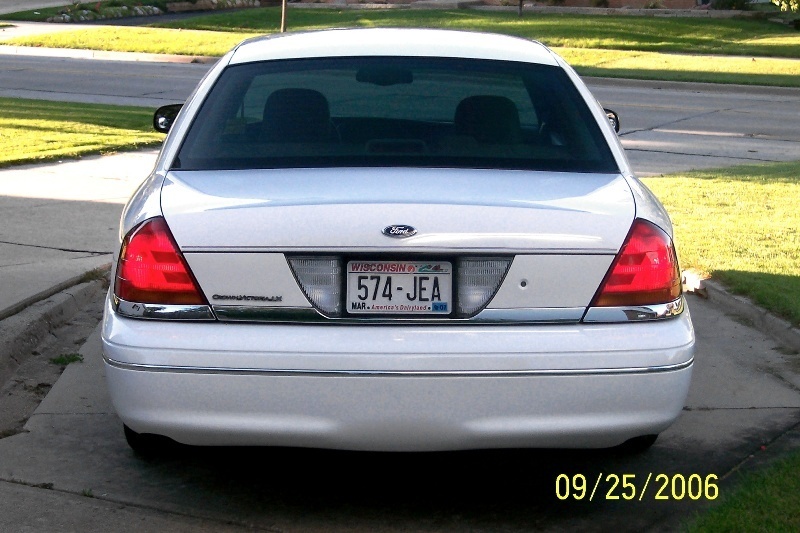 Rear view of a white 2003 Ford Crown Victoria with Wisconsin license plate 574-JEA