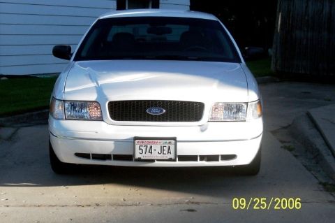 2003 Ford Crown Victoria - Front view of a white Ford Crown Victoria, parked on a concrete driveway. The date 09/25/2006 is visible.