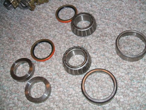 1974 Dodge Challenger - Several wheel bearings and seals are laid out on a carpeted surface, with a Supermotors.net watermark at the bottom right.