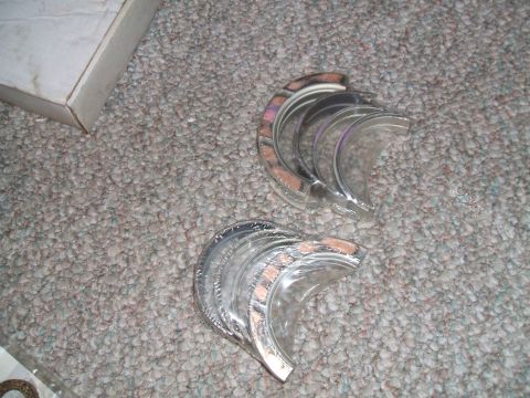 1974 Dodge Challenger - Engine bearings shown on carpet next to a box.