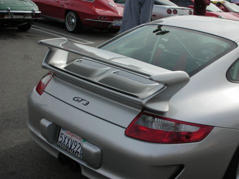 1998 Ford Crown Victoria - Close-up of a silver Porsche's rear deck showing the adjustable wing, GT3 script badge and a California license plate.