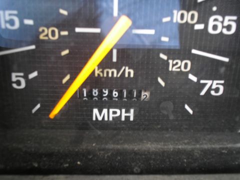 1999 Ford F-800 - Close-up of a vehicle's dashboard gauge, showing speed and mileage.