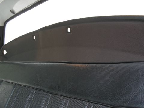 1999 Ford F-800 - Interior view of a vehicle's seat and headliner, showing a dark color scheme and three holes in the headliner.